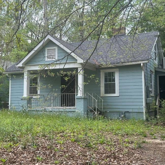 Blue single-story house with a small covered front porch.