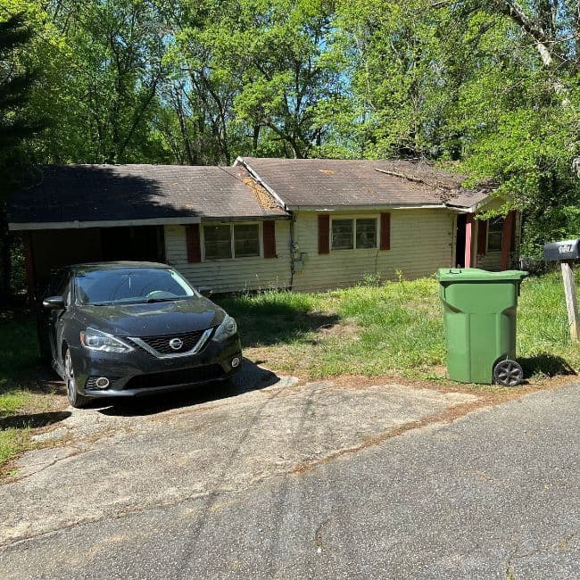 Yellow single-story house with a driveway in Kansas City.